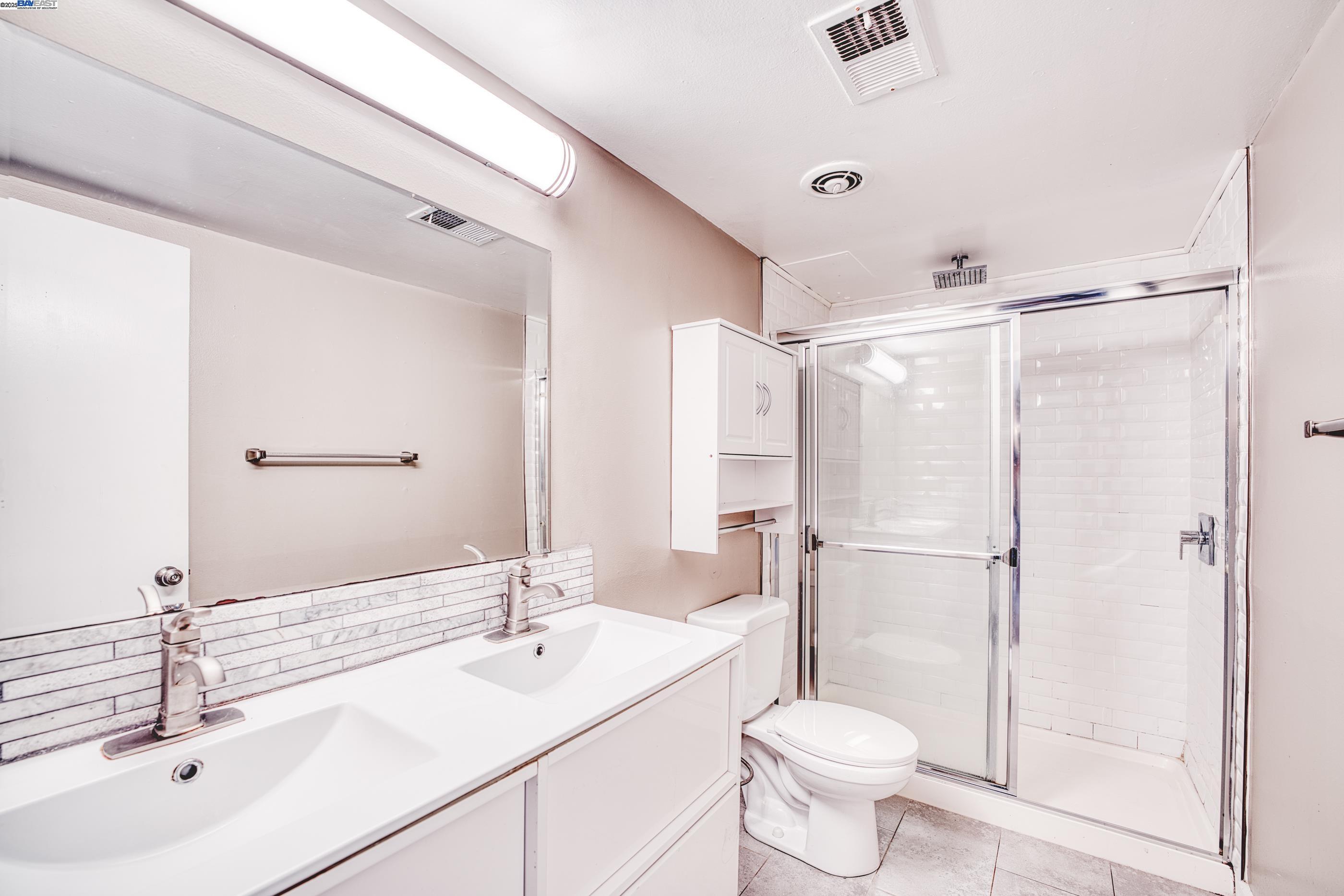 3815 Harrison Street, Unit 103 Oakland, CA 94611 - Photo 11 of 28 a bathroom with a sink toilet and shower