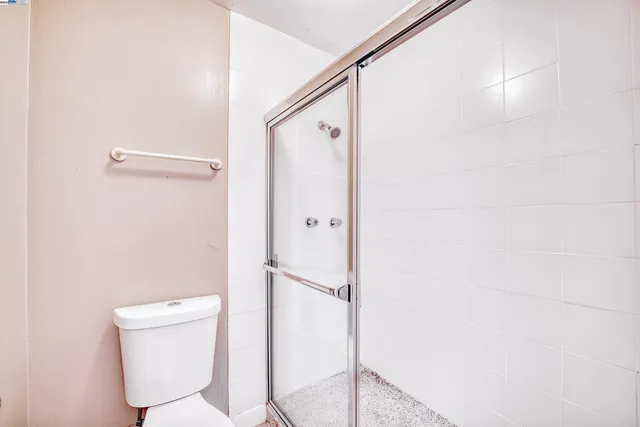 a bathroom with a toilet and a shower