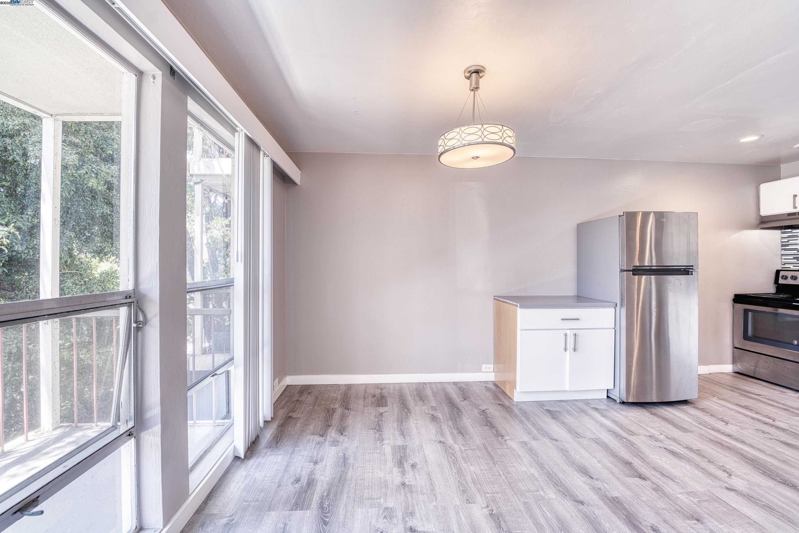 3815 Harrison Street, Unit 103 Oakland, CA 94611 - Photo 20 of 28 wooden floor in an empty room with a window
