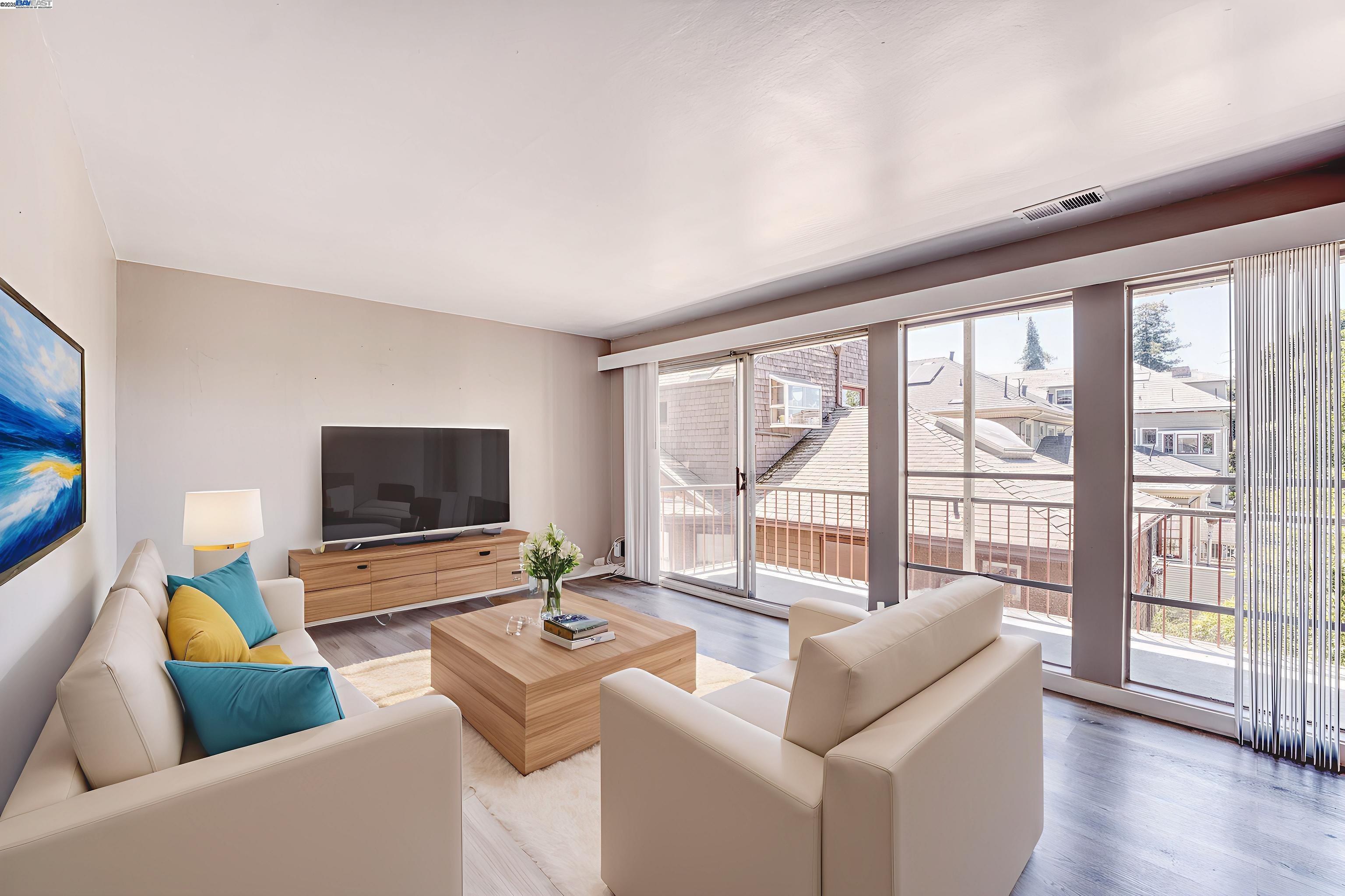 3815 Harrison Street, Unit 103 Oakland, CA 94611 - Photo 2 of 28 a living room with furniture and a flat screen tv