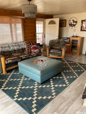a living room with furniture rug and window