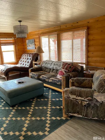 a bedroom with furniture and a large window