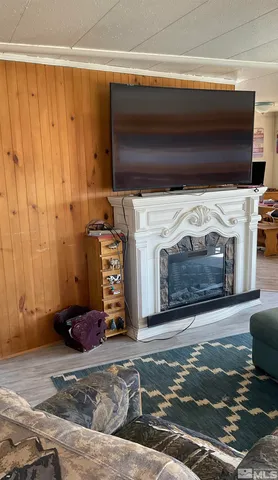 a living room with a fireplace and a flat screen tv