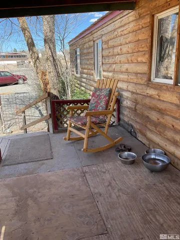 a view of a backyard with table and chairs