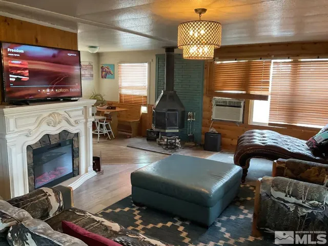 a living room with furniture fireplace and flat screen tv