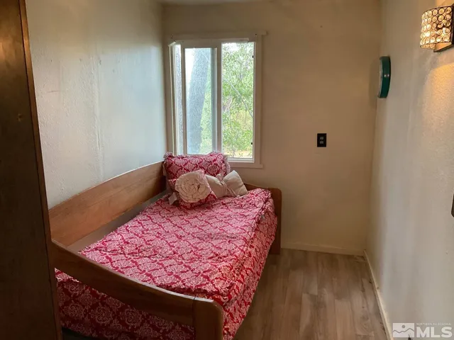 a bed sitting in a bedroom next to a window