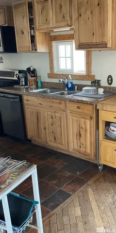 a kitchen with granite countertop a sink stove and cabinets