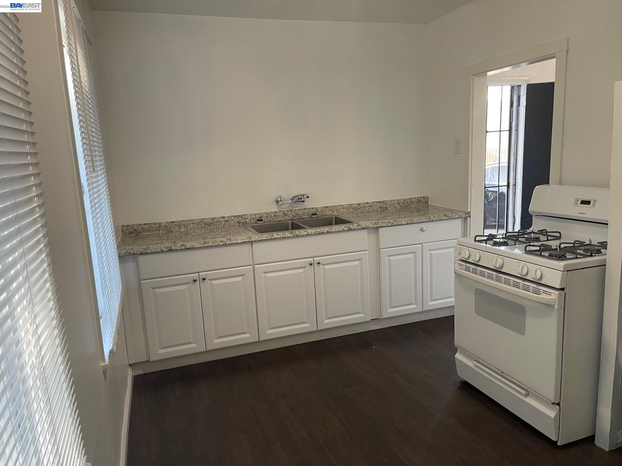 22622 2nd Street Hayward, CA 94541 - Photo 11 of 36 a kitchen with granite countertop white cabinets and white appliances