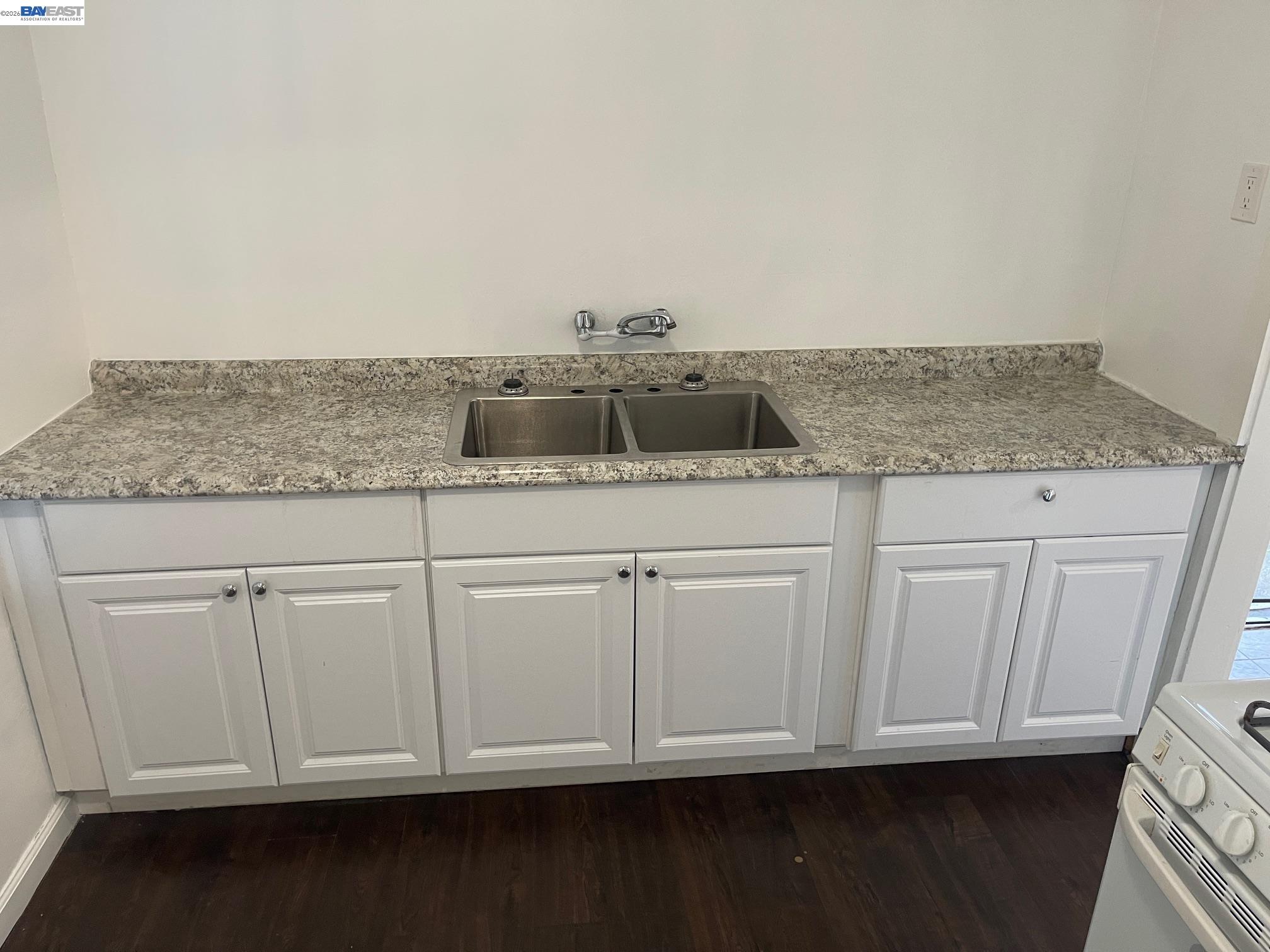 22622 2nd Street Hayward, CA 94541 - Photo 12 of 36 a kitchen with granite countertop white cabinets and a sink