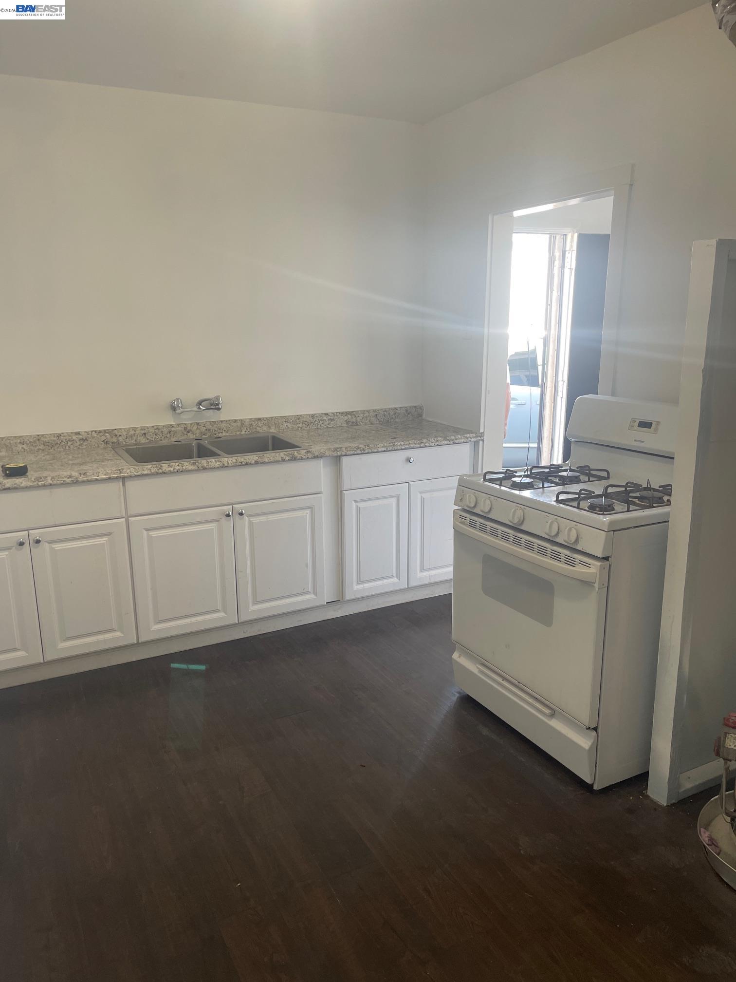 22622 2nd Street Hayward, CA 94541 - Photo 6 of 36 a kitchen with granite countertop white cabinets and white appliances
