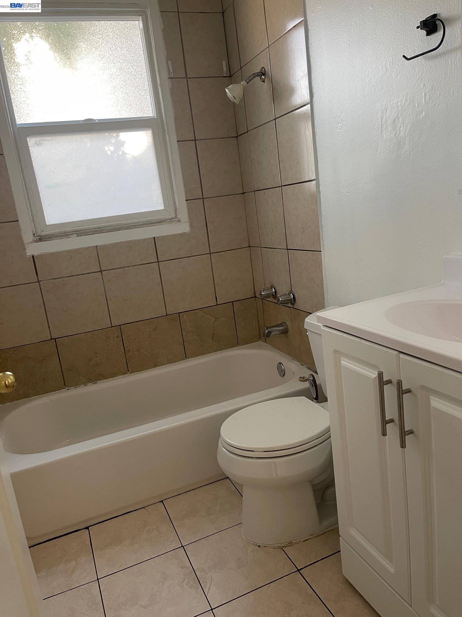22622 2nd Street Hayward, CA 94541 - Photo 10 of 36 a bathroom with a toilet a bath tub and a window