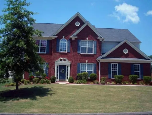 a front view of a house with a yard