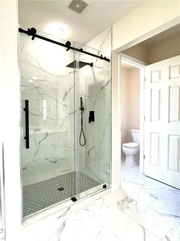 a bathroom with a shower and a sink