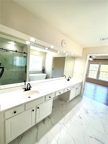 a large bathroom with a double vanity sink and a mirror