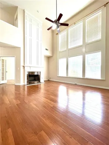 a view of a livingroom with a ceiling fan and window