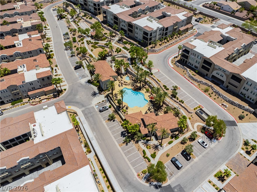 2555 Hampton Road, Unit 3308 Henderson, NV 89052 - Photo 58 of 65 An aerial perspective reveals a vibrant community with inviting pools, structured parking, and manicured landscaping.