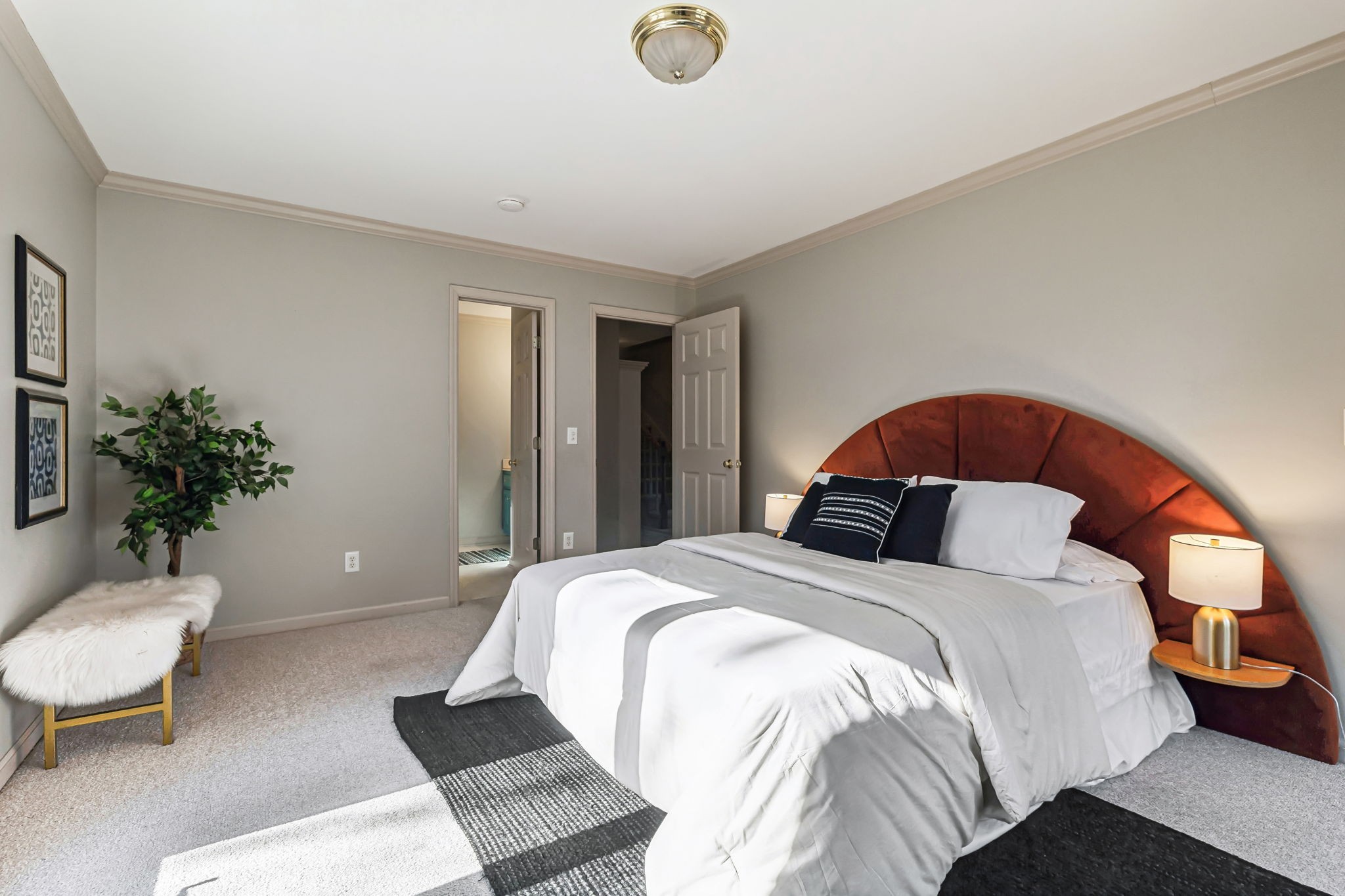 700 3rd Avenue West Springfield, TN 37172 - Photo 22 of 55 a bedroom with a large bed and a potted plant