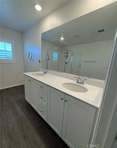 a bathroom with a double vanity sink and mirror