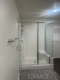 a bathroom with a glass shower door