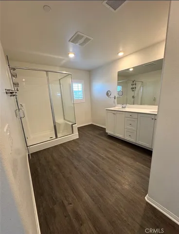 a kitchen with wooden floors and white walls