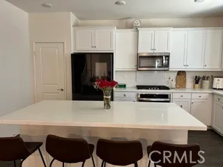 a kitchen with stainless steel appliances a stove a sink and a refrigerator