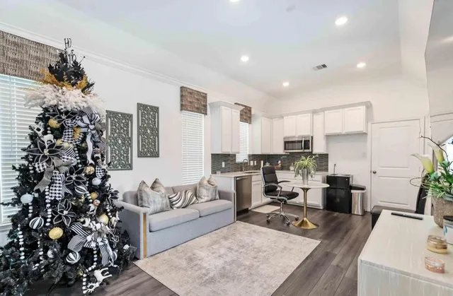 a living room with furniture and a potted plant