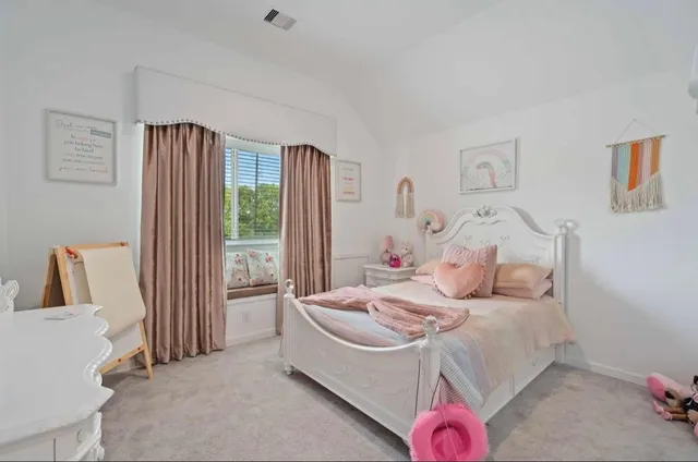 a bedroom with a bed and a dresser