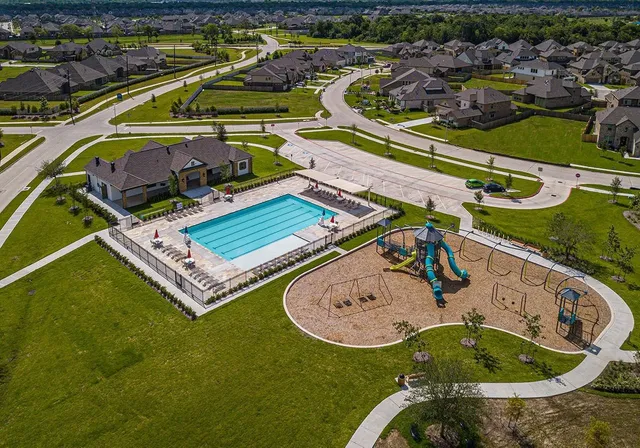 an aerial view of a house with a swimming pool outdoor seating and yard