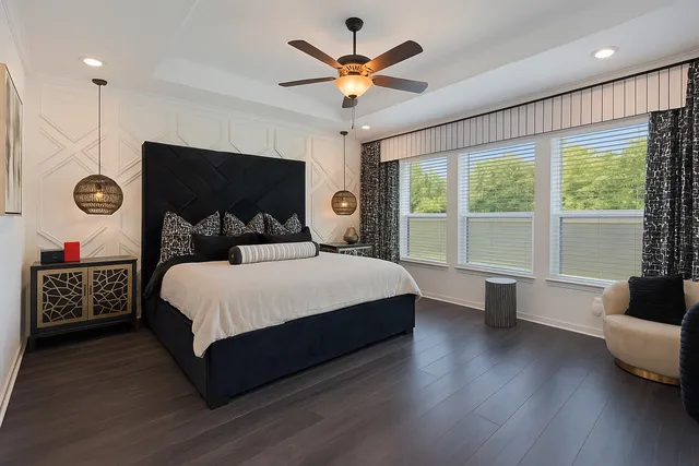 a bedroom with a large bed and a large window