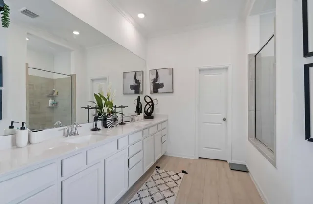a bathroom with a double vanity sink and a mirror