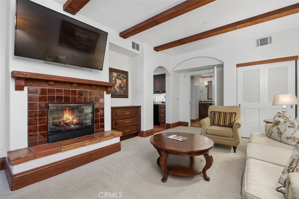 7323 Estrella De Mar Road, Unit 41 Carlsbad, CA 92009 - Photo 14 of 34 a living room with furniture a flat screen tv and a fireplace