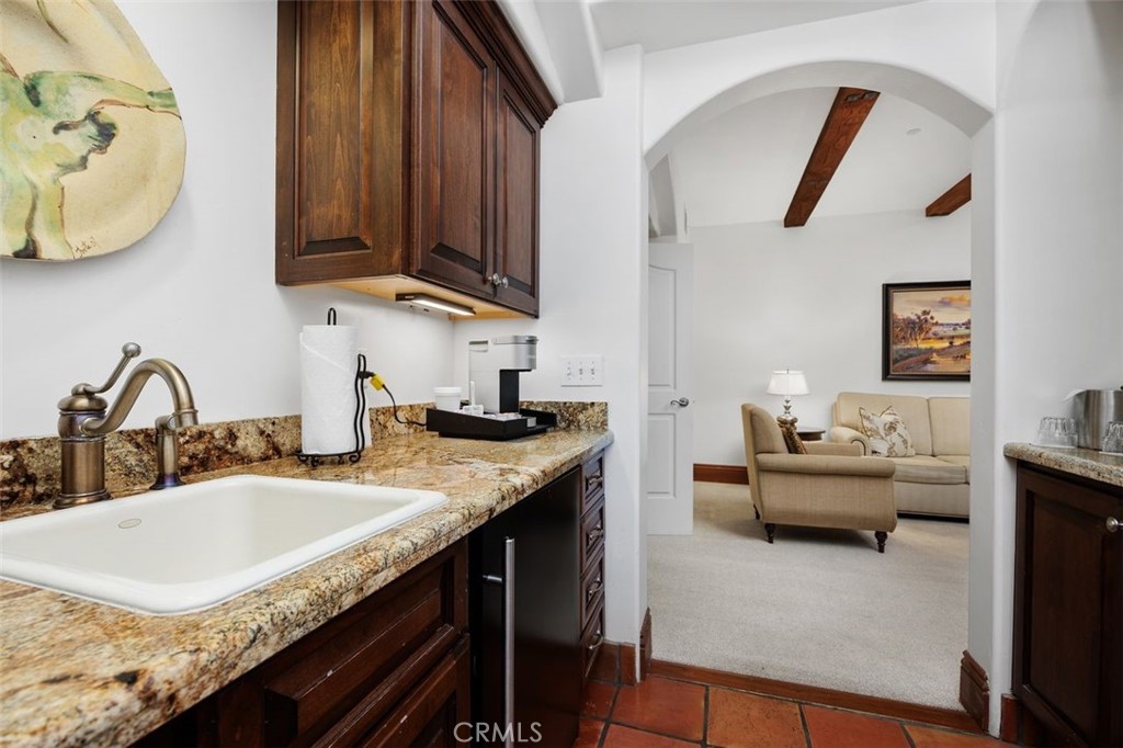 7323 Estrella De Mar Road, Unit 41 Carlsbad, CA 92009 - Photo 20 of 34 a kitchen with granite countertop a sink a stove and a wooden floor