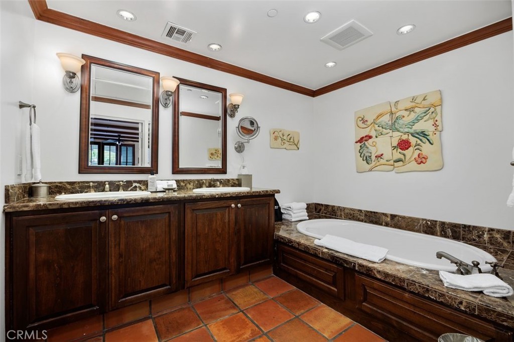 7323 Estrella De Mar Road, Unit 41 Carlsbad, CA 92009 - Photo 21 of 34 a spacious bathroom with a granite countertop tub and a sink