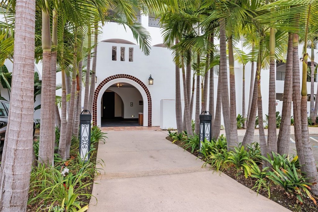 7323 Estrella De Mar Road, Unit 41 Carlsbad, CA 92009 - Photo 25 of 34 a view of a grey house with a small yard and plants