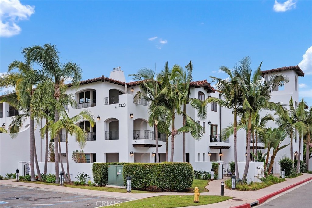 7323 Estrella De Mar Road, Unit 41 Carlsbad, CA 92009 - Photo 3 of 34 a view of a white house with a yard