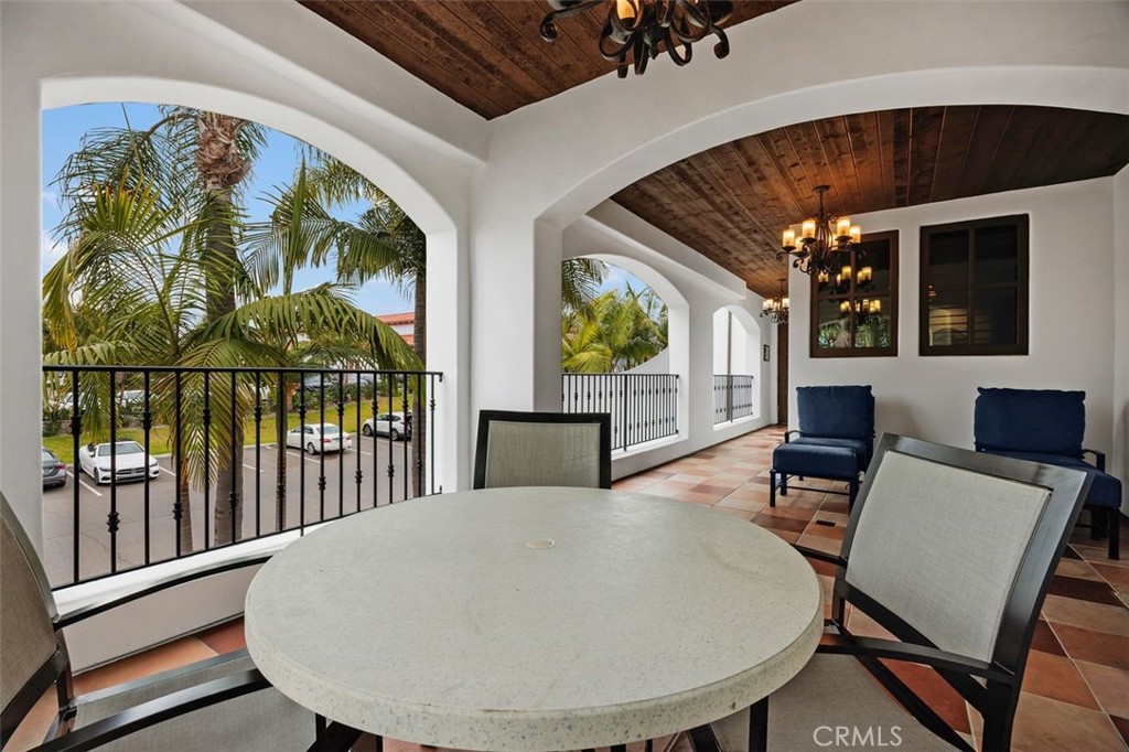 7323 Estrella De Mar Road, Unit 41 Carlsbad, CA 92009 - Photo 7 of 34 a view of a dining room with furniture wooden floor and chandelier