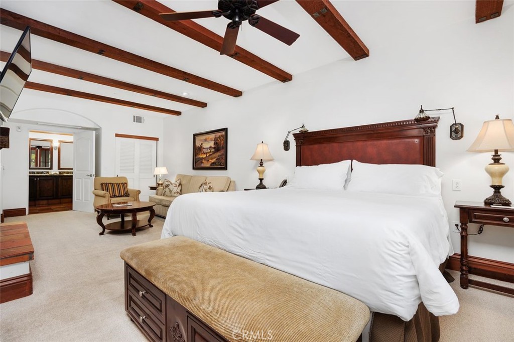 7323 Estrella De Mar Road, Unit 41 Carlsbad, CA 92009 - Photo 10 of 34 a bedroom with a bed and a chandelier