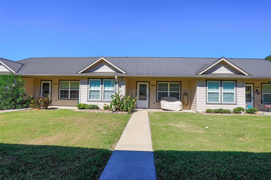 716 Rocky Ridge Flatts Oak Ridge, TX 76240 - Photo 1 of 10 Single story home with a front yard, covered porch, and a metal roof