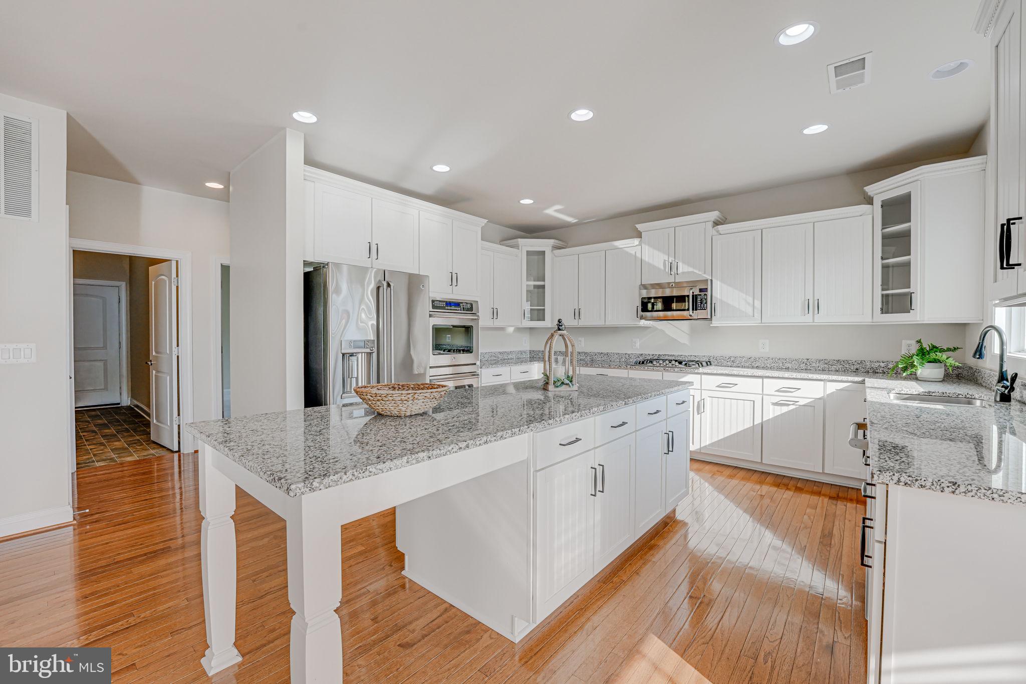 11708 Eagle Ridge Drive Spotsylvania, VA 22551 - Photo 12 of 75 a kitchen with stainless steel appliances granite countertop a sink stove and refrigerator