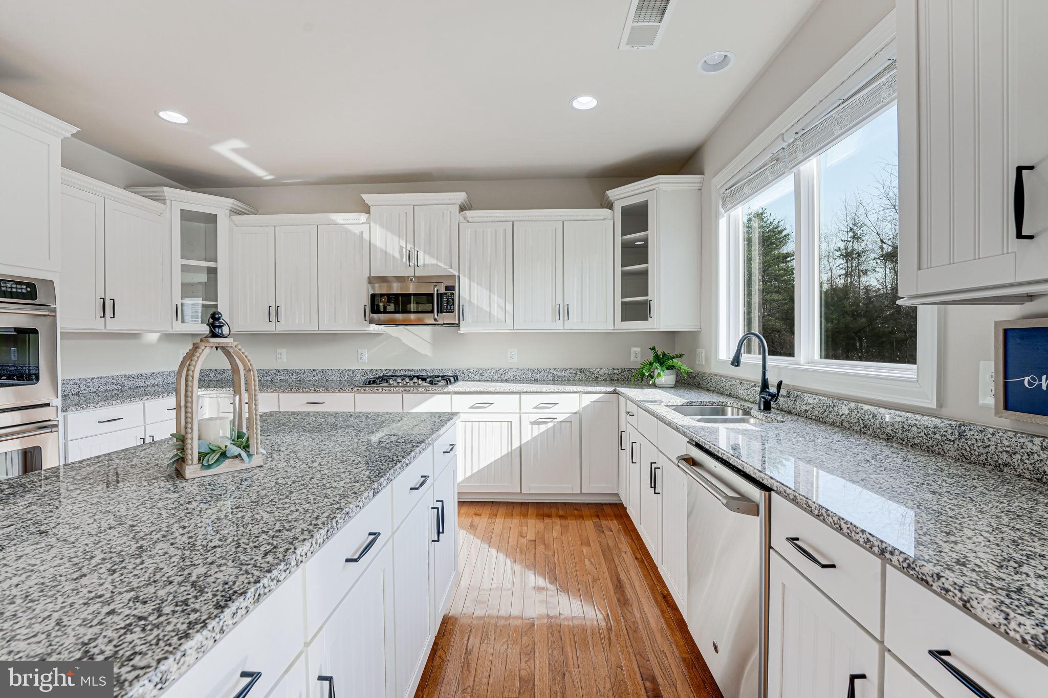 11708 Eagle Ridge Drive Spotsylvania, VA 22551 - Photo 13 of 75 a kitchen with granite countertop a sink stove and cabinets