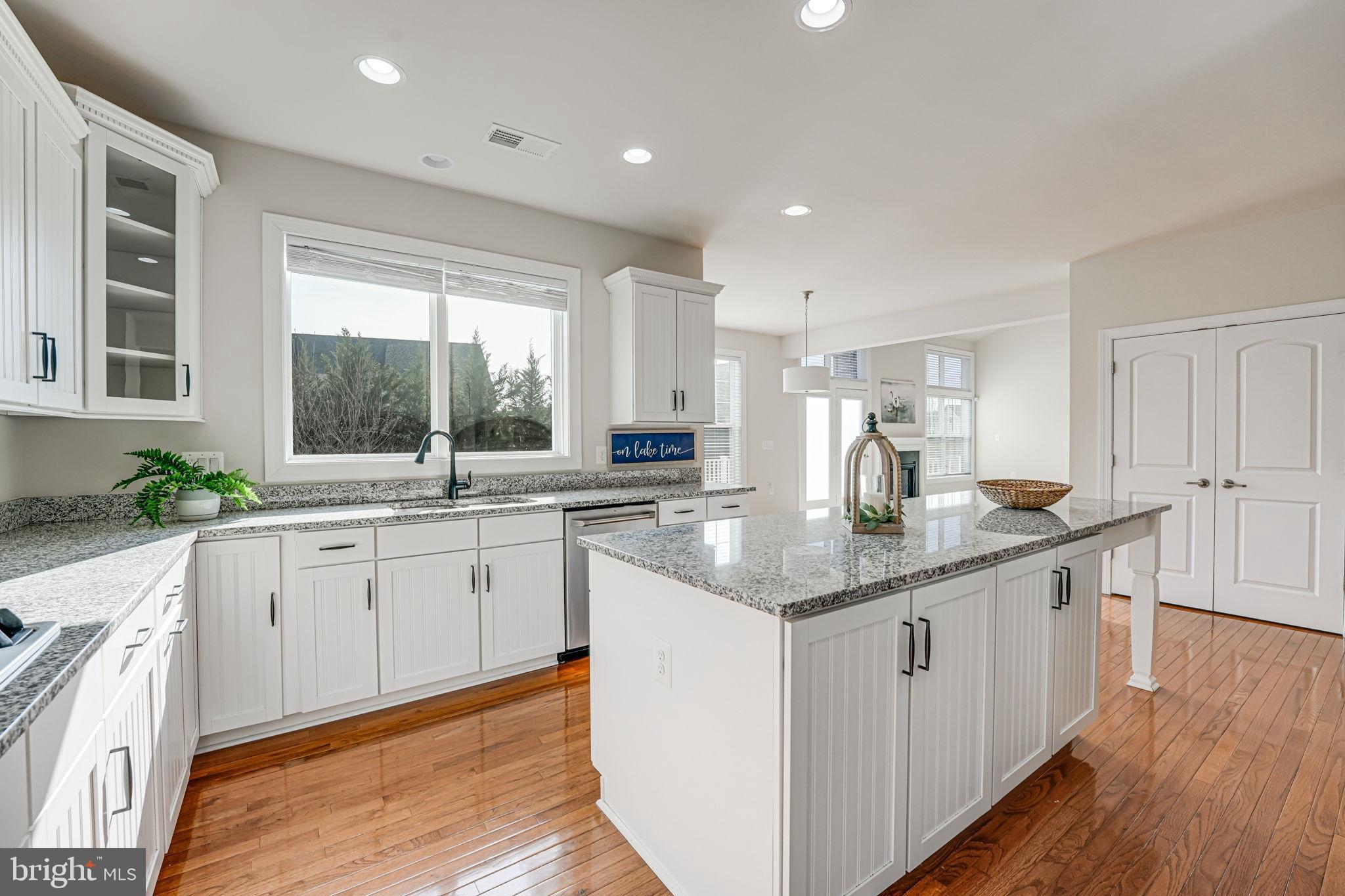 11708 Eagle Ridge Drive Spotsylvania, VA 22551 - Photo 15 of 75 a kitchen with granite countertop kitchen island white cabinets and sink