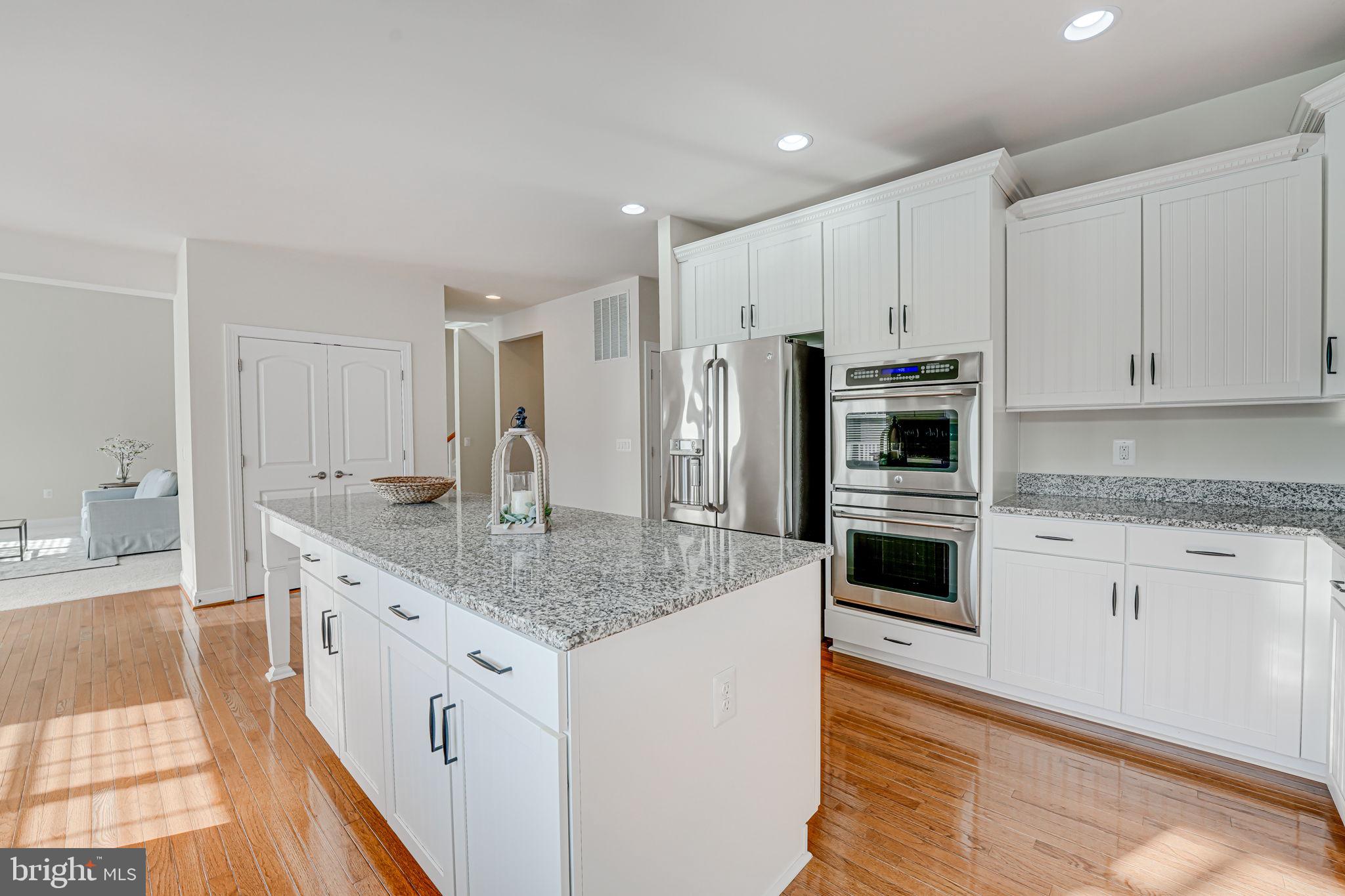 11708 Eagle Ridge Drive Spotsylvania, VA 22551 - Photo 17 of 75 a kitchen with granite countertop a sink stove and refrigerator