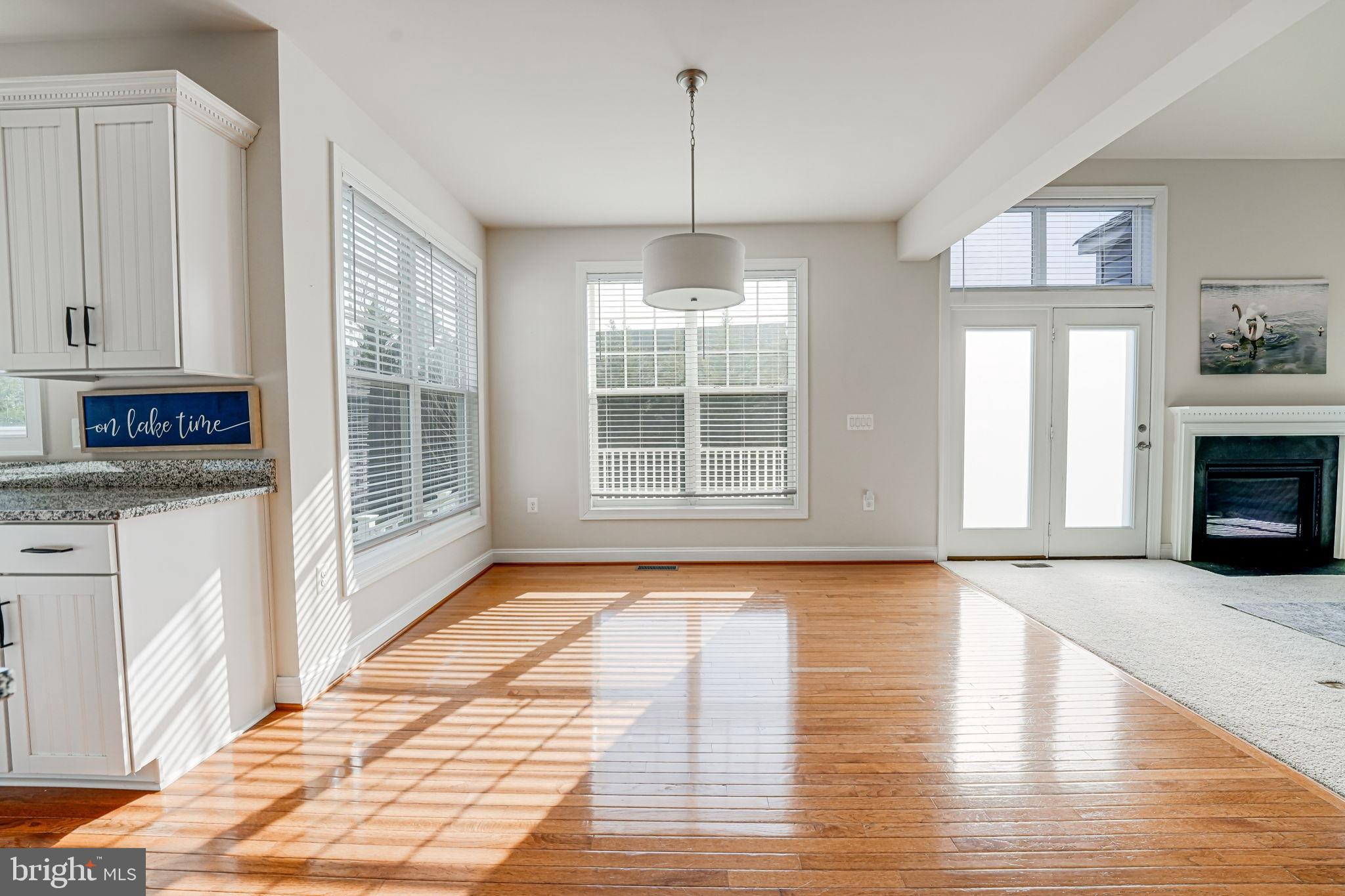 11708 Eagle Ridge Drive Spotsylvania, VA 22551 - Photo 18 of 75 a view of an empty room with wooden floor and a window
