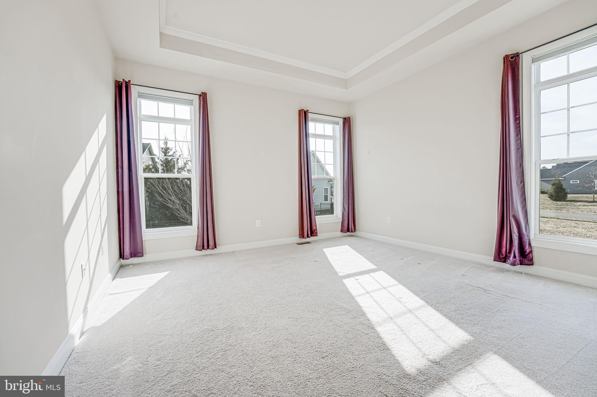 11708 Eagle Ridge Drive Spotsylvania, VA 22551 - Photo 22 of 75 a view of an empty room with wooden floor and a window