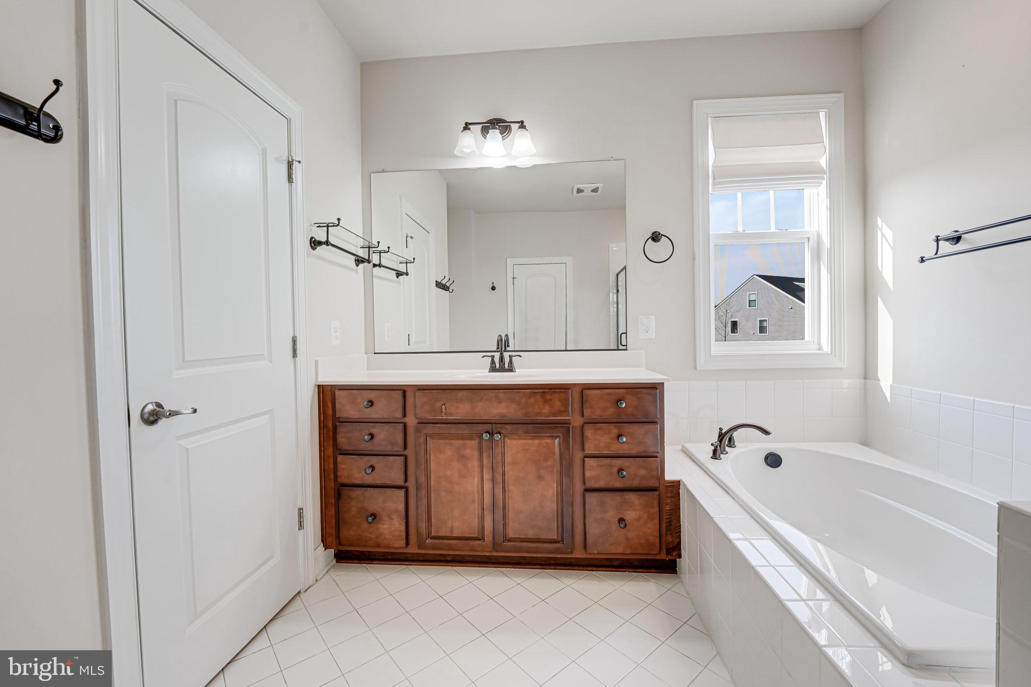11708 Eagle Ridge Drive Spotsylvania, VA 22551 - Photo 25 of 75 a spacious bathroom with a tub double sink and mirror