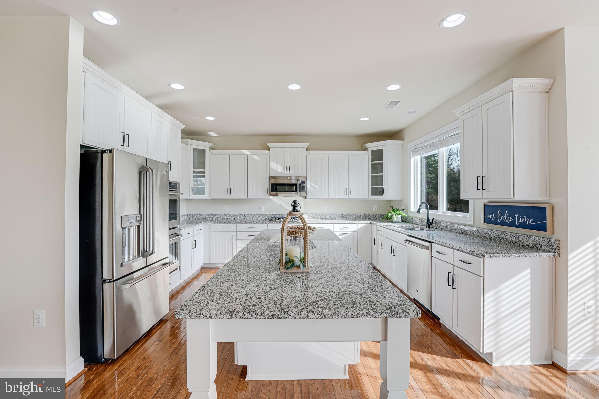 11708 Eagle Ridge Drive Spotsylvania, VA 22551 - Photo 3 of 75 a kitchen with stainless steel appliances granite countertop a sink stove and refrigerator