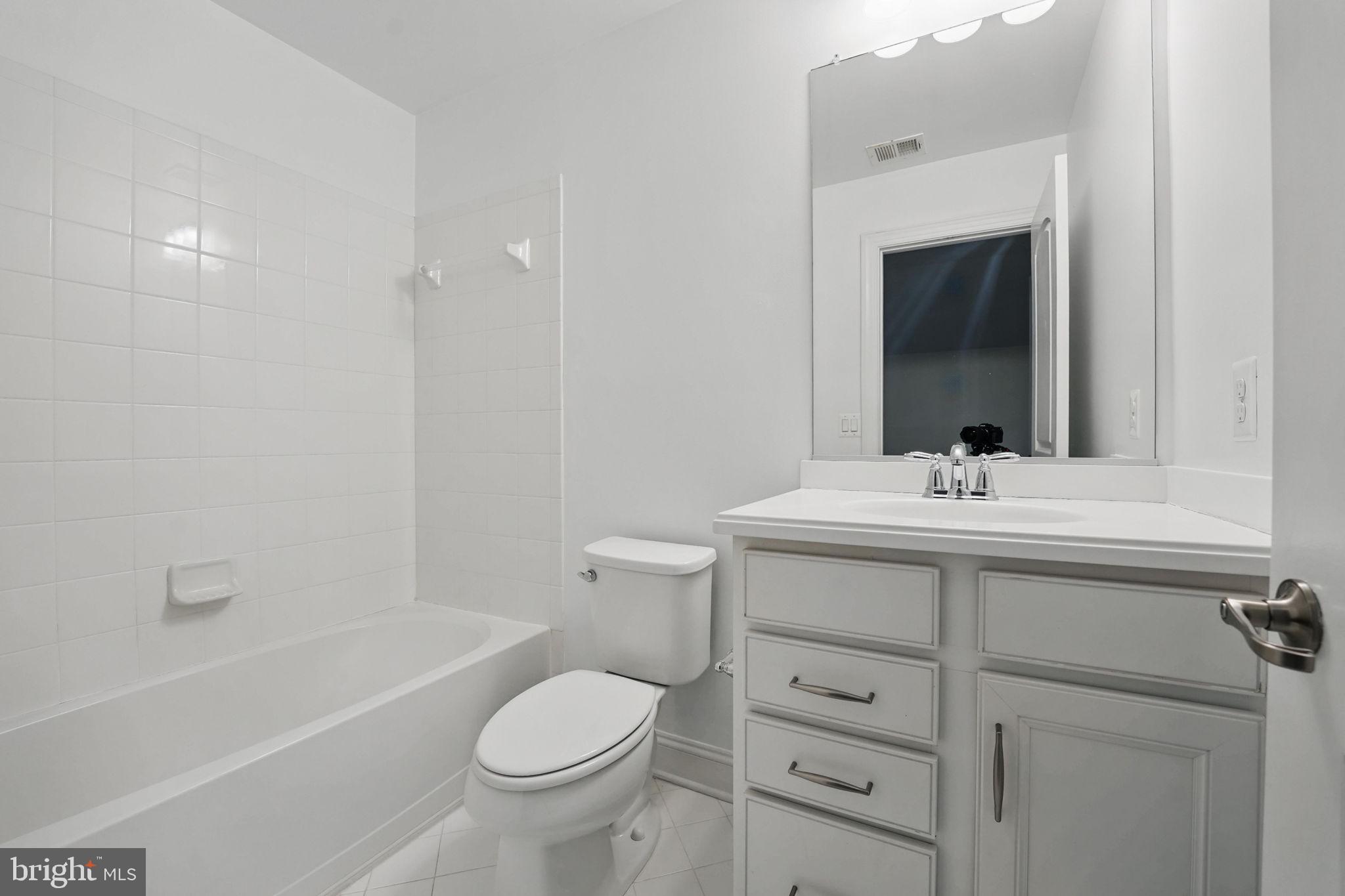 11708 Eagle Ridge Drive Spotsylvania, VA 22551 - Photo 34 of 75 a bathroom with a sink a toilet and shower