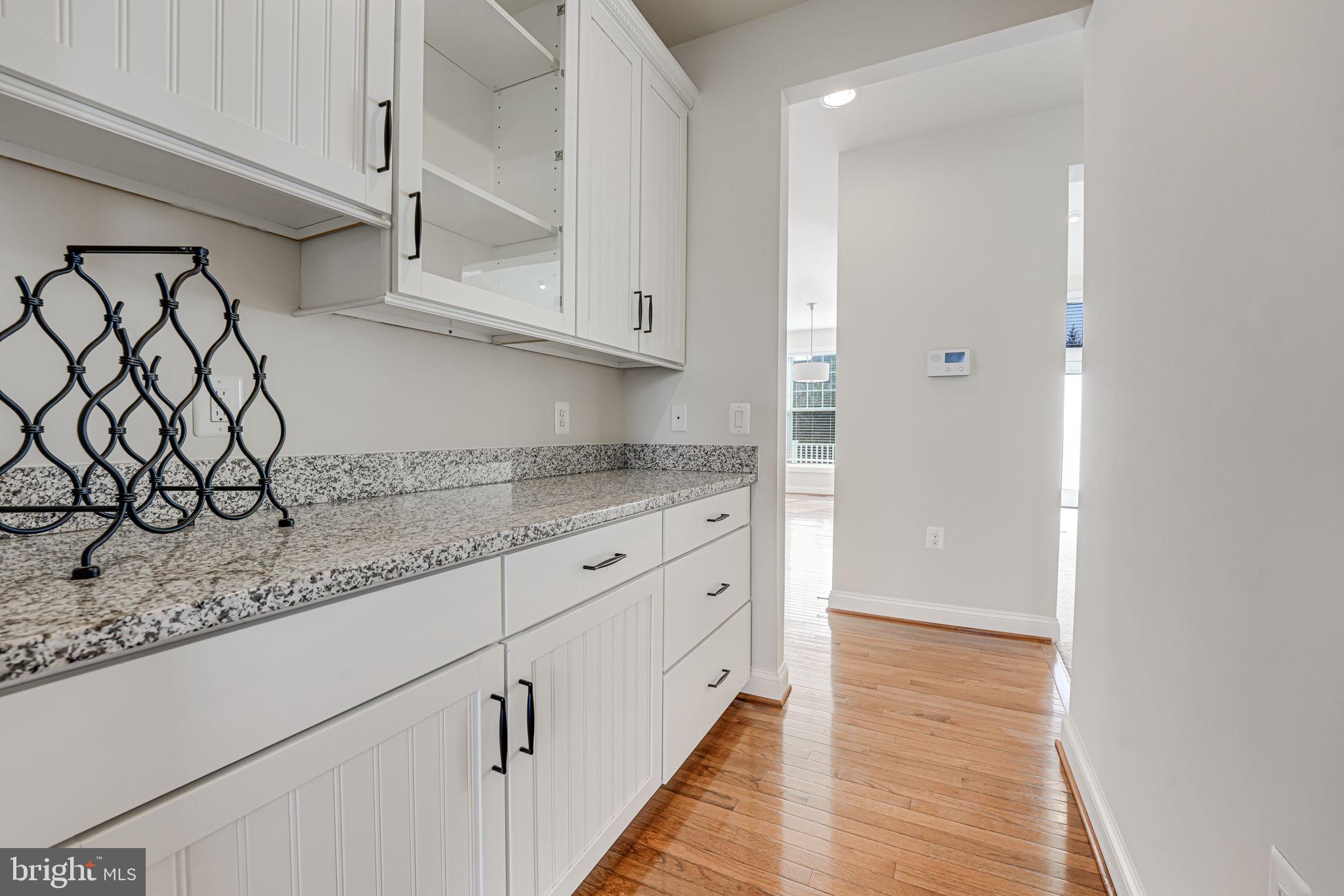 11708 Eagle Ridge Drive Spotsylvania, VA 22551 - Photo 8 of 75 a kitchen with granite countertop white cabinets and white appliances