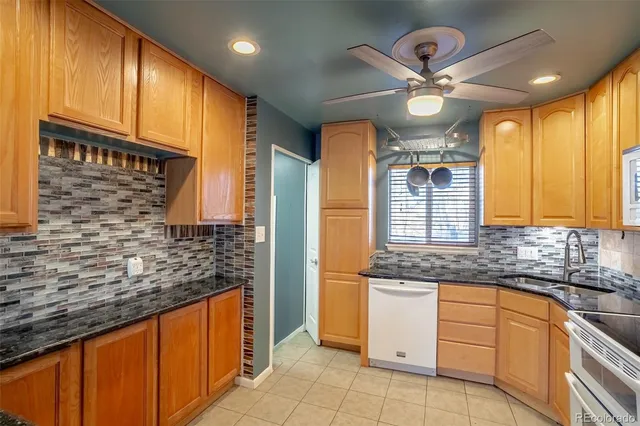 a kitchen with stainless steel appliances granite countertop a sink and cabinets