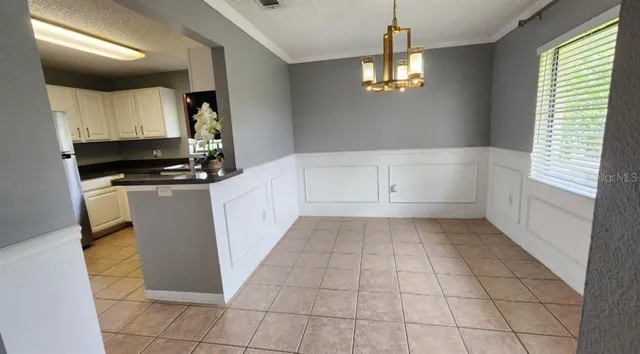 a kitchen with granite countertop a stove a sink and a refrigerator
